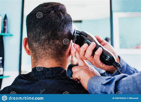 Latin Barber Shop, Mexican Barber Cutting Hair with a Clipper Machine ...