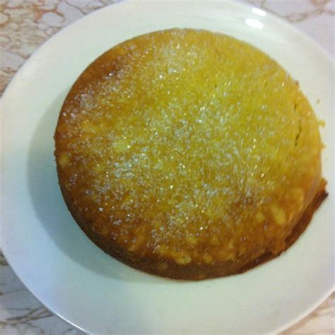 side view of Vaselopita - Greek New Years Cake dusted with powdered sugar with a slice cut out of it
