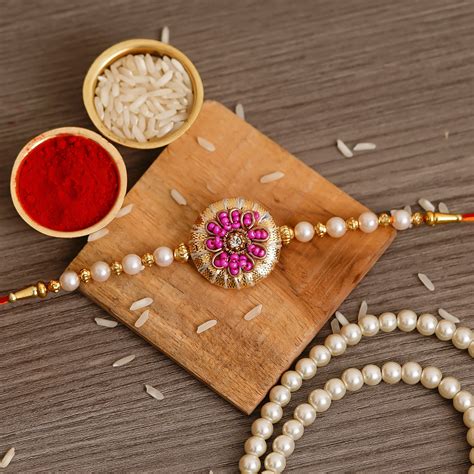 Pink & Golden Pearl Rakhi and Roli Chawal Pack - eCraftIndia Online