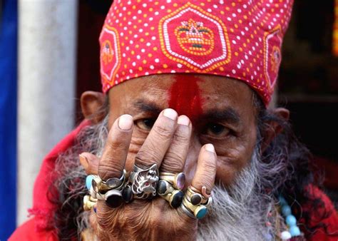A sadhu applies tilak at the Babughat transit camp ahead of the Ganga ...