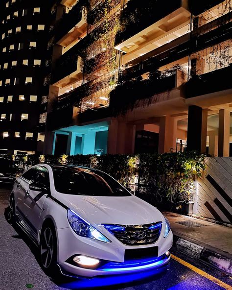 Hyundai Sonata Parked in Front of a Tall Building at Night