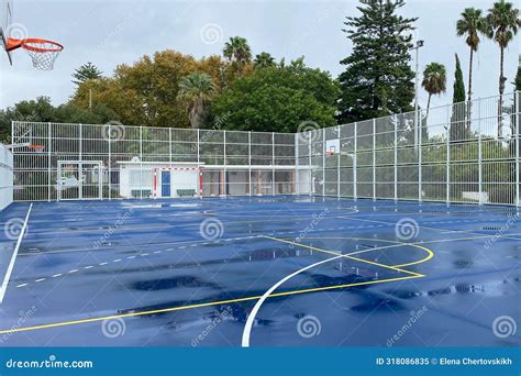 Outdoor Basketball Court with White and Blue Gates and Netting. Stock ...