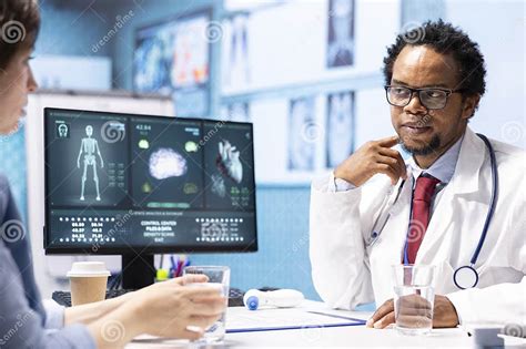 Image of a doctor and a patient reviewing a scan.