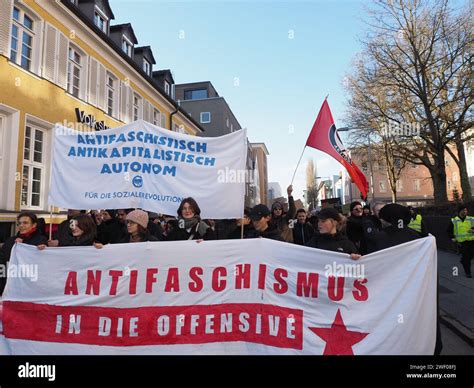 Young people with a banner "Anti-fascism in action" lead a column of ...