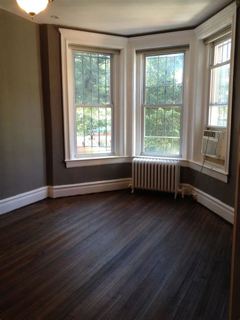 Living room bay windows. Creek bend Behr grey paint. Dark walnut stain ...