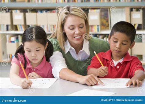 Teacher Helping Students with Writing Skills Stock Image - Image of ...