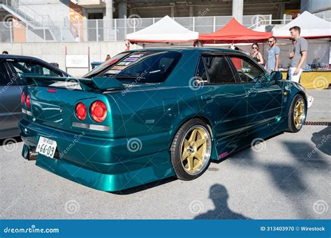 Rear View of a Tenth Generation Green Nissan Skyline GT R34 at a ...
