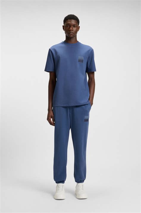 HUGO - Cotton-terry tracksuit bottoms with split logo - Blue