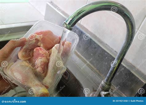 Thawing Frozen Chicken or Poultry Meat on Running Water on a Sink ...