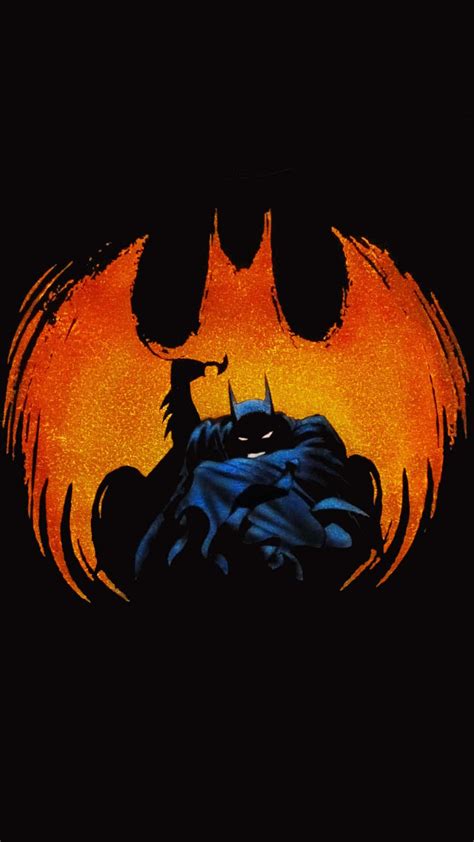 Download Batman standing against the backdrop of a haunting full moon ...