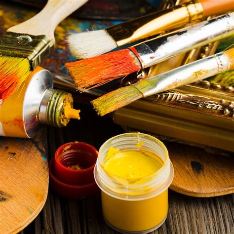High view coloured paint and brushes close-up | Free Photo