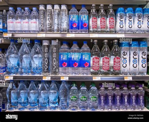Rows of name brand bottled waters on grocery store shelves Stock Photo ...