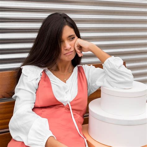 Front view of woman sitting on bench with boxes | Free Photo