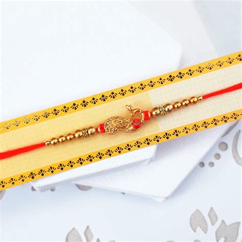 Send Attractive Golden Peacock Rakhi to Thailand Online | Rakhibazaar.com