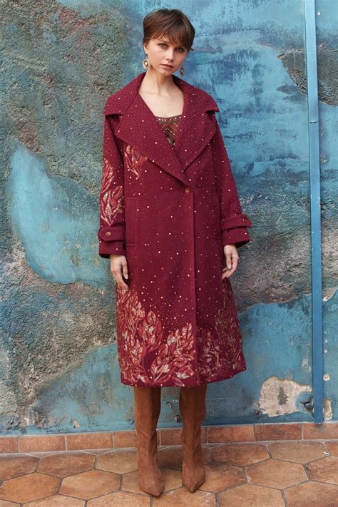 Red embroidered trench with printed appliqué.