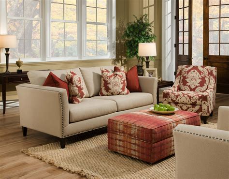 Beige twin couches face each other over natural hardwood flooring and ...