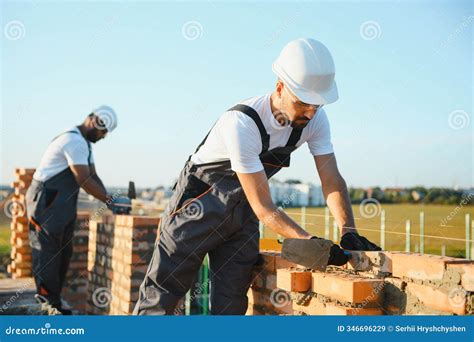Professional Construction Workers Build a Brick House. Industrial Theme ...