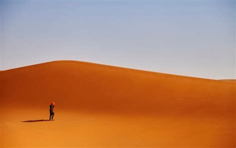 Man standing on desert against clear sky | Premium Photo