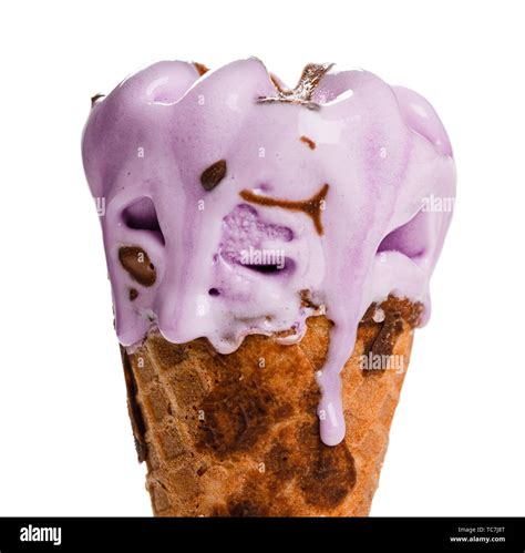 sweet potato flavor ice cream cone melting with drips close up on white ...