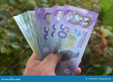Man Holds Cook Islands Dollar and New Zealand Banknotes Stock Image ...