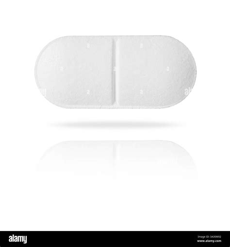 A white oblong tablet with a visible score line is placed on a ...