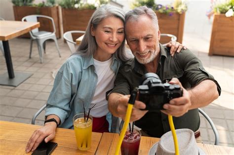 Medium shot people taking selfie with camera | Free Photo