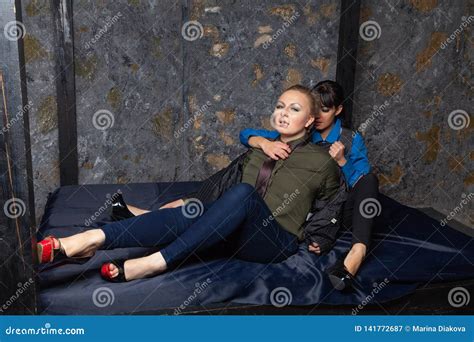 Two Lesbian Girls Making Love on a Black Bed in Their Bedroom Stock ...