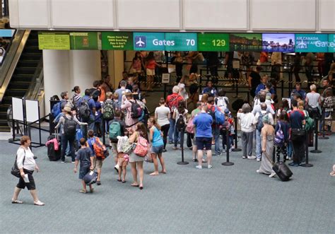 Passengers look at flight delays on a departure board at Orlando International Airport on November 0