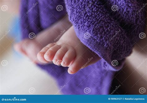 Baby feet in purple towel stock image. Image of foot - 90963127