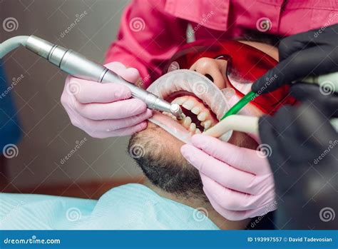 Professional Teeth Cleaning. Dentist Cleans the Teeth of a Male Patient. Stock Image - Image of ...