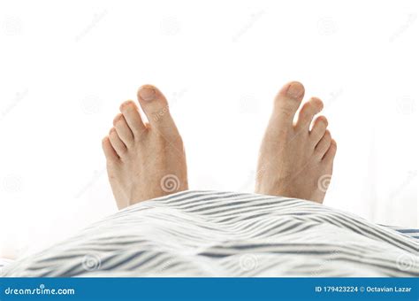 Caucasian Male Bare Feet with Crooked Toe Poking Out of Under the Bed ...