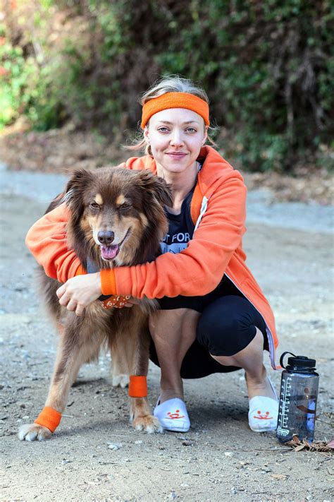 Amanda Seyfried poses with her Australian Shepherd dog Finn as she ...