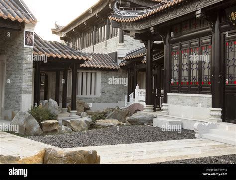 Photo of an elaborate Chinese temple with hedges in front.
