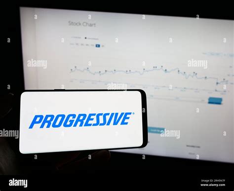 Person holding mobile phone with logo of US insurance company The ...