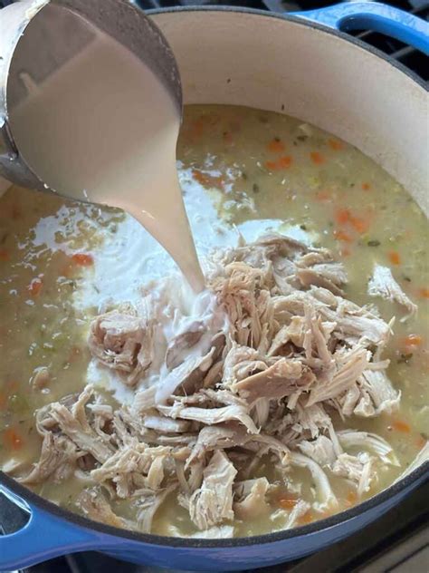 https://www.bowlofdelicious.com/wp-content/uploads/2024/01/creamy-chicken-rice-soup-adding-chicken-768x1024.jpg?utm_source=chatgpt.com