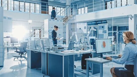 Diverse team of engineers working on computers program and manipulate ...