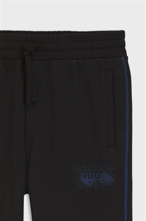 HUGO - Cotton-terry tracksuit bottoms with logo and contrast stitching ...