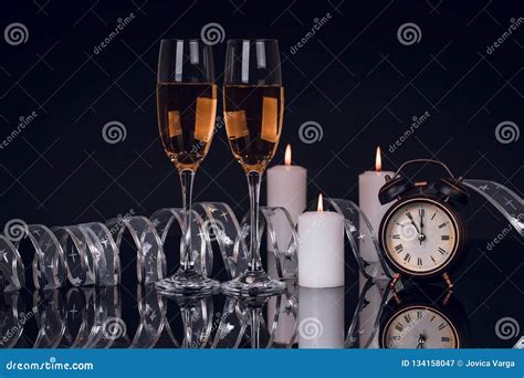 Two Glasses with Champagne, Clock and Candles Stock Image - Image of ...