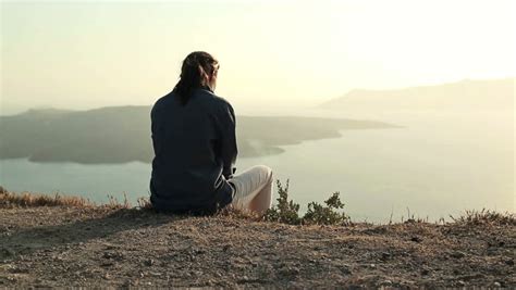 alone woman sitting on cliff looking Stock Footage Video (100% Royalty ...
