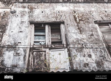 Aged building with dirty walls and broken window in Stone Town ...