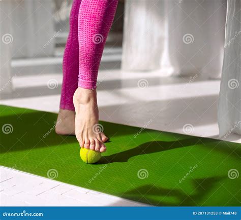Massage for Feet with Tennis Ball. Woman Practicing Foot Self-massage ...