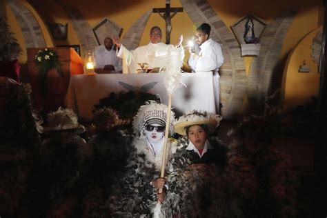 Despite rainy weather, Catholics in a Paraguayan town dress as birds to honor their patron saint