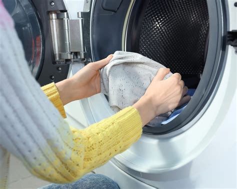 Guest using on-site laundry facility at Blue Mist Motel.