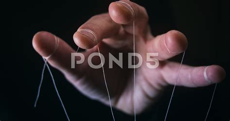 Hand Holding Puppet Strings
