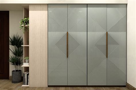 Sea green wardrobe design with geometric pattern on laminate