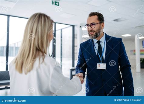 Pharmaceutical Sales Representative Talking with Doctor in Medical Building, Clinic Lobby ...