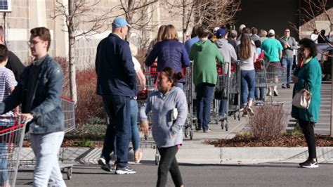 People stand in lines at an Upper East Side grocery store in New York.