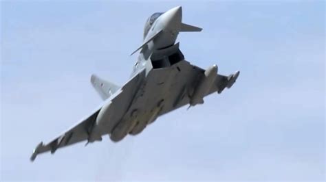 Royal Air Force ground crew preparing an RAF Typhoon fighter jet. It is night-time and the team are