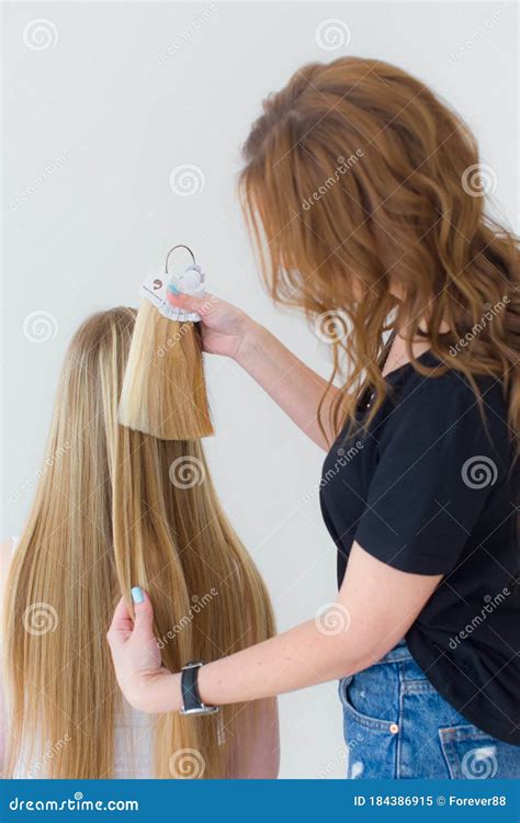 Shot of Young Girl Chooses Hair Color from a Tester of Hair Strands in ...