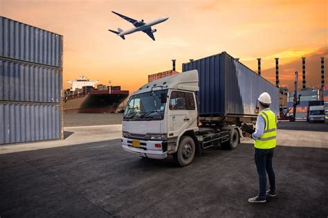 Foreman control loading containers box to truck | Premium Photo